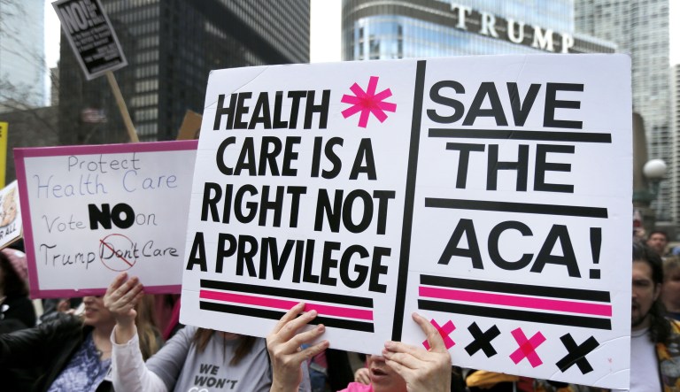 Protesters gather across from Trump Tower to rally against the repeal of the Affordable Care Act, March 24, 2017, in Chicago.