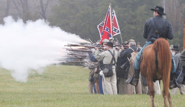 Confederate troops fire muskets at Union troops during a re-enactment of the Battle of Appomattox Courthouse at Appomattox Court House in Appomattox, Va.  