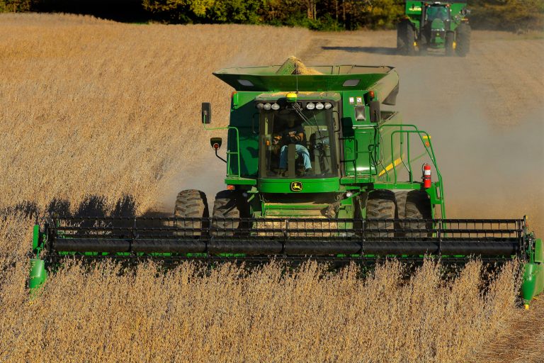 In this 2014 file photo, a central Illinois farmer uses a John Deere combine to harvest his soybean field in Loami, Ill.