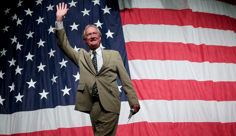 Former Rhode Island Gov. Lincoln Chafee walks off the stage after speaking.