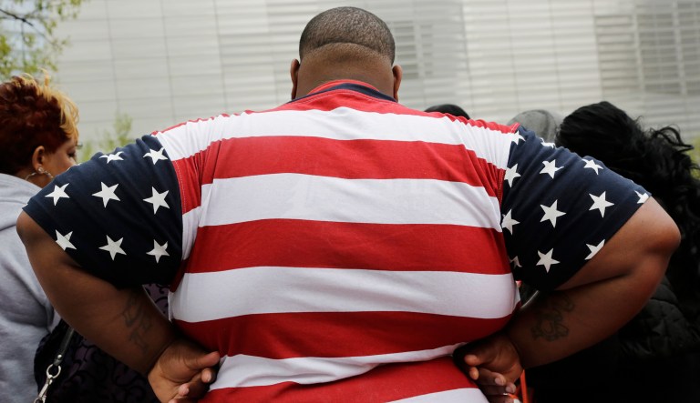 In this Thursday, May 8, 2014 photo, an overweight man wears a shirt patterned after the American flag during a visit to the World Trade Center, in New York.