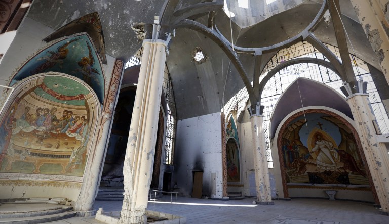 Damaged walls are seen inside Sayydet al-Sallam Church in the old city of Homs, Syria, on Tuesday, Dec. 8, 2015.