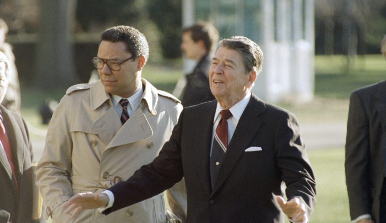 President Ronald Reagan, accompanied by national security adviser Colin Powell, leaves the White House in Washington, Dec. 16, 1988 for a trip to the University of Virginia in Charlottesville. 