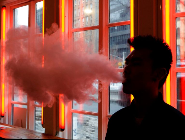 In this 2014 file photo, a man exhales vapor from an e-cigarette in New York.