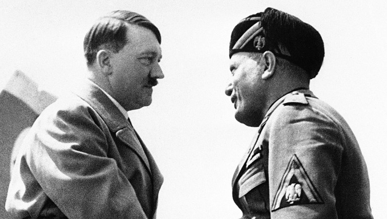 Dictators Adolf Hitler of Germany, at left, and Benito Mussolini of Italy, greeting each other as they meet at the airfield in Venice, northern Italy.