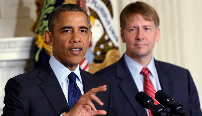 President Barack Obama, left, speaks as he stands with Richard Cordray, right, the new director of the Consumer Financial Protection Bureau, during a statement in the State Dining Room of the White House in Washington, Wednesday, July 17, 2013. The Senate voted on Tuesday, July 16, 2013, to end a two-year Republican blockade that was preventing Cordray from winning confirmation as director of the Consumer Financial Protection Bureau.