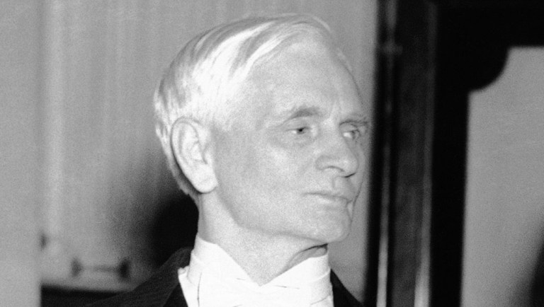 Sen. Thomas P. Gore, blind senator from Oklahoma, presides at a reception in Washington.