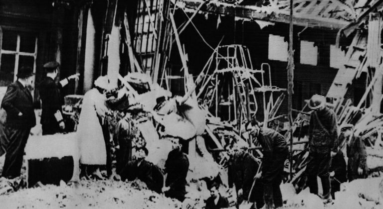 Prime Minister Winston Churchill (left), together with King George (Pointing) and Queen Elizabeth (speaking to men in bomb crater) inspect damage done by German war raiders to a section of Buckingham Palace in London, Sept. 10, 1940. The King and Queen were away at the time the delayed action bomb exploded.