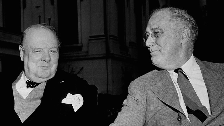 British Prime Minister Winston Churchill and President Franklin D. Roosevelt talk together at the White House.