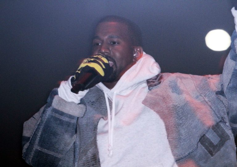Kanye West performs during a concert.
