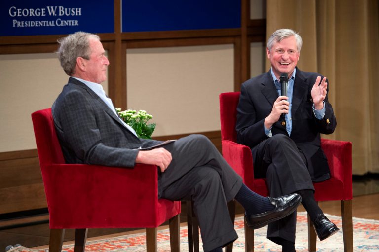 Pulitzer Prize winning author Jon Meacham, right, discusses his biography of former President George H. W. Bush with Bush's son, former President George W. Bush, Sunday, Nov. 8, 2015 at the George W. Bush Presidential Center in Dallas.
