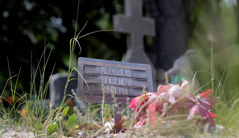 A marker with "Unknown Remains" marks the grave of an unidentified immigrant, Wednesday, June 25, 2014, at a cemetery in Falfurrias, Texas. 