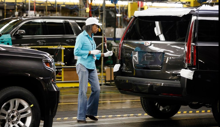 Sheila Collins inspects an SUV at the General Motors plant in Arington, Texas, Tuesday, July 14, 2015.