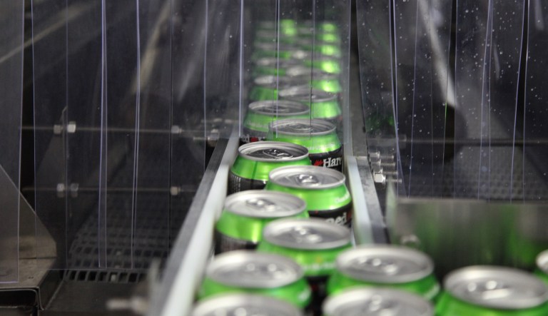 Beer cans move down the production line at a microbrewery's canning facility.