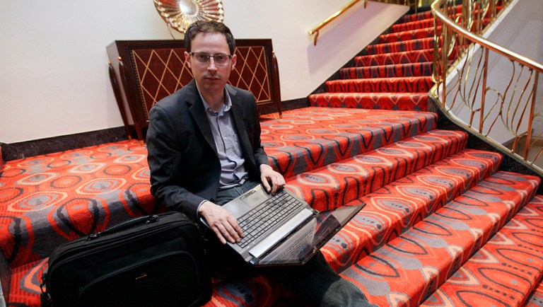 Nate Silver sits on the stairs at Allegro hotel in downtown Chicago.