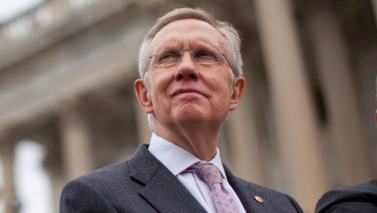 Former Senate Majority Leader Harry Reid of Nev. stands on the Senate steps on Capitol Hill.