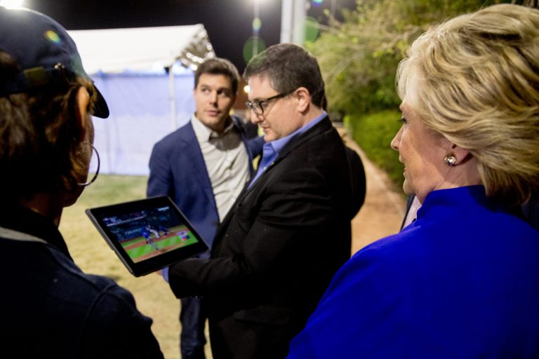 In this 2016 photo, outside advisor Philippe Reines (center) watches the 2016 World Series baseball game with Democratic presidential candidate Hillary Clinton (right) and Traveling Press Secretary Nick Merrill (center left).