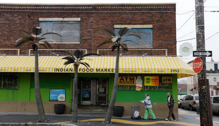 Customers walk to the the Indiana Food Market in Philadelphia.