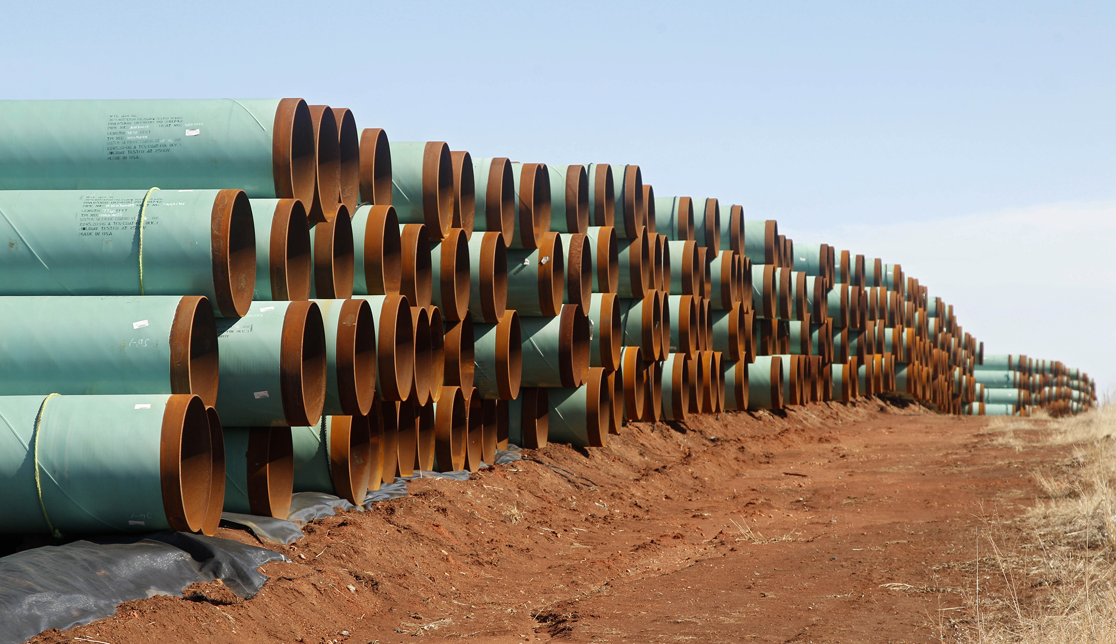 Miles of pipe for the Canada-to-Texas Keystone XL pipeline are stacked in a field near Ripley, Okla.