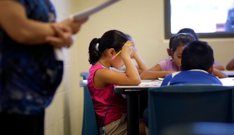 In this Sept. 10, 2014, photo, children sit in class at the Karnes County Residential Center, a temporary home for immigrant women and children detained at the border in Karnes City, Texas.