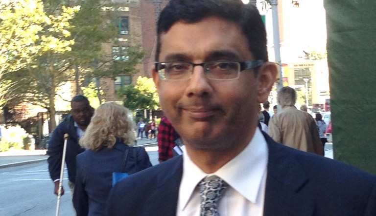 Dinesh D'Souza leaves federal court in New York, Tuesday, Sept. 23, 2014 after being sentenced to spend eight months in community confinement and undergo therapeutic counseling for arranging straw donors for a Senate candidate. D'Souza was spared from prison even though U.S. District Judge Richard M. Berman said the defendant continues to deflect responsibility and minimize his crime.