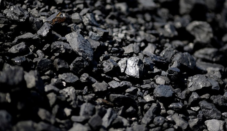 In this May 22, 2014, file photo, sunlight reflects off of a chunk of coal at Dominion Terminal Associates' coal terminal in Newport News, Va.