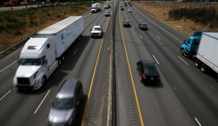 Cars and trucks move along Interstate 5. Washington state regulators released an updated plan Wednesday to limit greenhouse gas emissions from large polluters. Also on Wednesday, Gov. Jay Inslee joined leaders from Oregon, California and British Columbia in San Francisco to sign a climate agreement that includes encouraging the use of zero-emissions vehicles. 