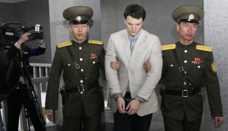 American student Otto Warmbier, center, is escorted at the Supreme Court in Pyongyang, North Korea, Wednesday, March 16, 2016. 