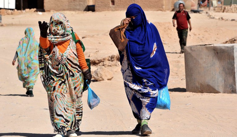 Sahrawi women walk through the Smara refugee camp near Tindouf, south-western Algeria, Friday, March 4, 2016. U.N. chief Ban Ki-moon is expected to arrive in Tindouf on March 5 to visit Sahrawi refugee camps.  Ban Ki-moon will meet with leaders of the Polisario Front, the organization disputing sovereignty over Western Sahara with Morocco, in the hope to help solving a 40-year conflict.