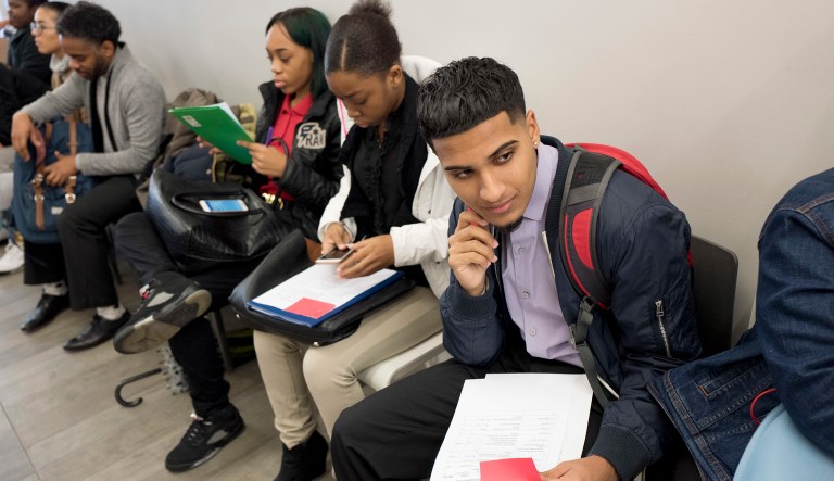 Young job seekers wait to meet with recruiters during a job fair. The fair is part of the Urban Youth Jobs Program for 16 to 24-year-olds.