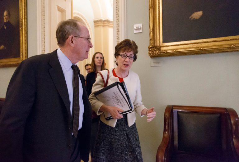 Sen. Lamar Alexander, R-Tenn., left, and Sen. Susan Collins, R-Maine, walk to a closed-door GOP meeting before the Senate moves to pass a modest, bipartisan budget bill, at the Capitol in Washington, Wednesday, Dec. 18, 2013.