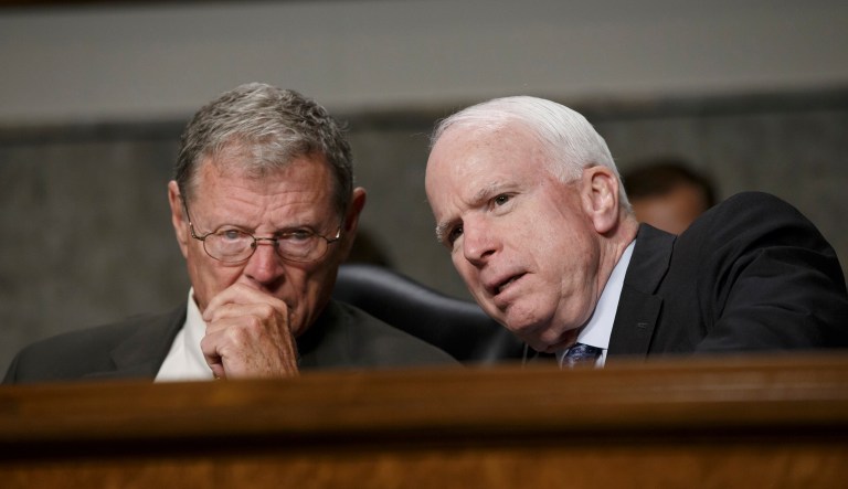 Sen. James Inhofe, R-Okla., and Sen. John McCain, R-Ariz., confer at a Senate Armed Services Committee hearing on April 3, 2014.