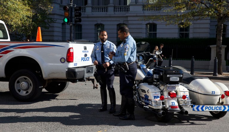 Washington Metropolitan Police work on 17th St NW by the Eisenhower Executive Office Building near the White House in Washington, Monday, Nov. 16, 2015, during a protest of the Trans-Pacific Partnership (TPP).
