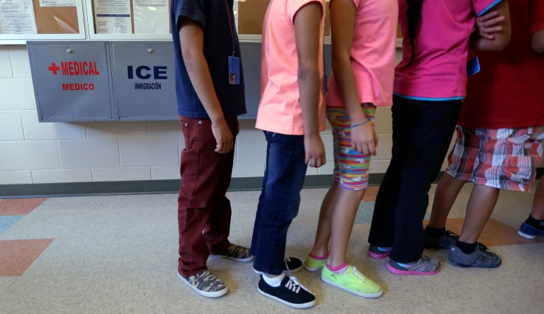 Detained immigrant children line up in the cafeteria at the Karnes County Residential Center, a temporary home for immigrant women and children detained at the border in Karnes City, Texas, on Sept. 10, 2014.