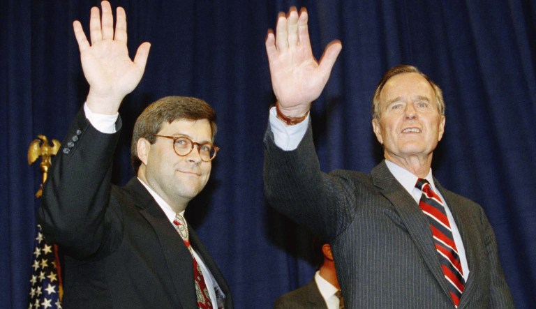 U.S. President George H. Bush, right, and William Barr wave after Barr was sworn in as the new Attorney General of the United States, Tuesday, Nov. 26, 1991 at a Justice Department ceremony in Washington.