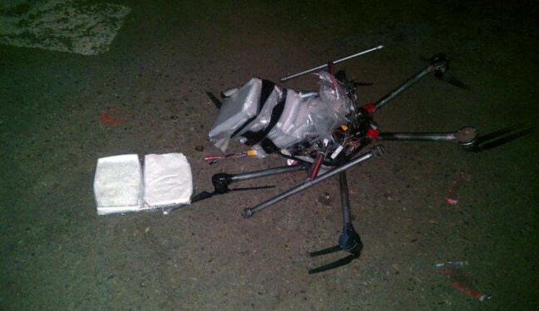 In this image released by the Tijuana Municipal Police on Wednesday Jan. 21, 2015, a drone loaded with packages containing methamphetamine lies on the ground after it crashed into a supermarket parking lot in the city of Tijuana on Tuesday Jan. 20, 2015.