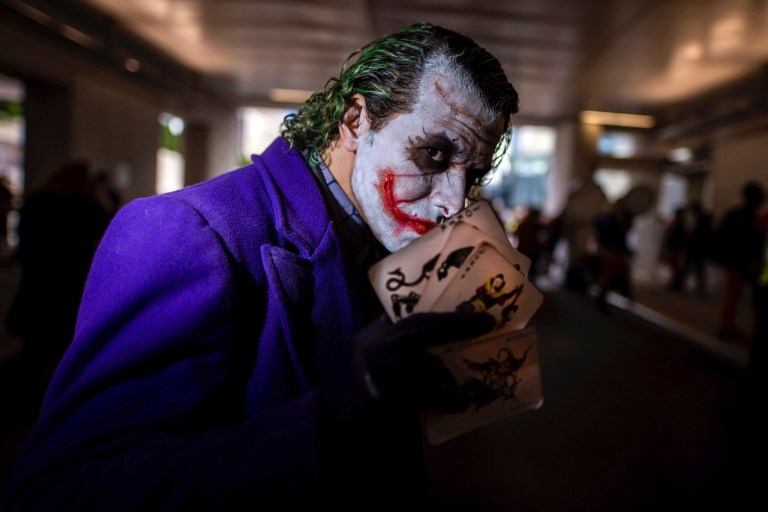 An attendee dressed as the Joker poses during New York Comic Con at the Jacob K. Javits Convention Center on Friday, Oct. 4, 2019, in New York.