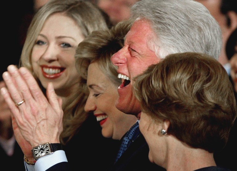 Former President Bill Clinton laughs, Monday, June 14, 2004, as then-President Bush tells a story about Clinton campaigning for McGovern in Texas. Clinton along with his daughter Chelsea Clinton, left, former first lady and then Sen. Hillary Rodham Clinton, D-NY, center, and first lady Laura Bush, right, participated in a ceremony for the unveiling of the Clinton portraits in the East Room of the White House.