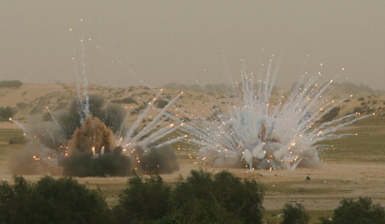 White phosphorous munitions are blown up by UN and Hamas sappers, not seen, in Khan Younis refugee camp, southern Gaza Strip, Monday, March 15, 2010. 