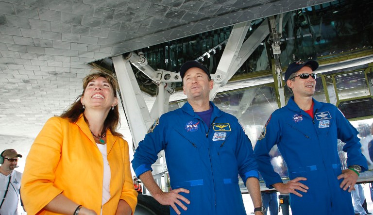 NASA deputy administrator Lori B. Garver, left, looks at the tiles on the space shuttle Atlantis with STS-132 commander Ken Ham, center, and mission specialist Michael Good after the orbiter landed safely on Kennedy Space Center's runway 33 Wednesday, May 26, 2010, in Cape Canaveral, Fla.