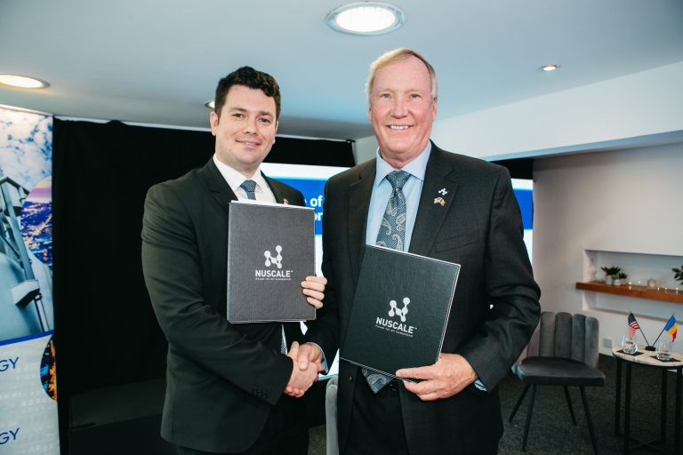 John Hopkins (right), the chairman and CEO of NuScale Power, is seen in this 2021 photo with Cosmin Ghita, the CEO of Nuclearelectrica.