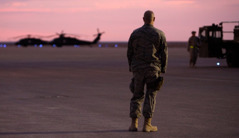 A U.S. soldiers stands on the tarmac before making his journey home from al-Asad airbase west of Baghdad, Iraq, Tuesday, Nov. 1 , 2011. More than a decade later, and U.S. troops in Syria and Iraq have come under frequent attacks in October and November 2023 as tension boils in the Middle East with Israel's war against Hamas. (AP Photo/Khalid Mohammed)