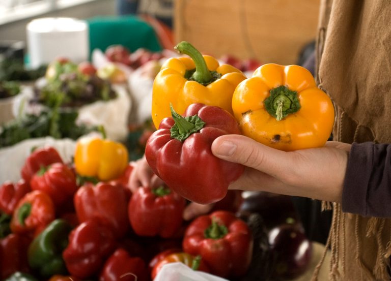 A customer picks through a variety of peppers while shopping at The City Market in Kansas City, Missouri.