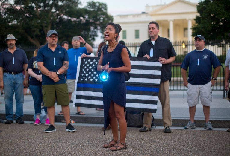 Michelle Malkin, center, a blogger and political commentator, leads a gathering of supporters of law enforcement officers carried blue lights during a pro-police rally held in front of the White House in Washington, Friday, July 22, 2016. Today she was suspended from Twitter for 12 hours.