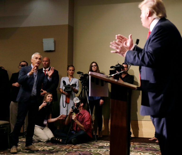 In this Aug. 25, 2015, file photo, Univision anchor Jorge Ramos, left, asks then Republican presidential candidate Donald Trump a question about his immigration proposal during a news conference in Dubuque, Iowa. Ramos was later removed from the room.