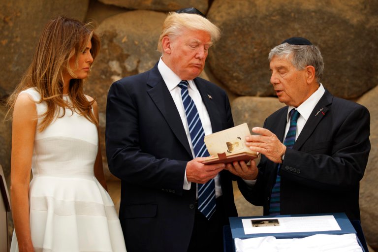 First lady Melania Trump looks on as Avner Shalev, Chairman of the Yad Vashem Directorate, right, presents U.S President Donald Trump a replica of a personal notebook of holocaust victim Ester Goldstein, Tuesday, May 23, 2017, in Jerusalem. President Donald Trump solemnly paid tribute Tuesday to the 6 million Jews killed during the Holocaust, calling on the world to never forget 