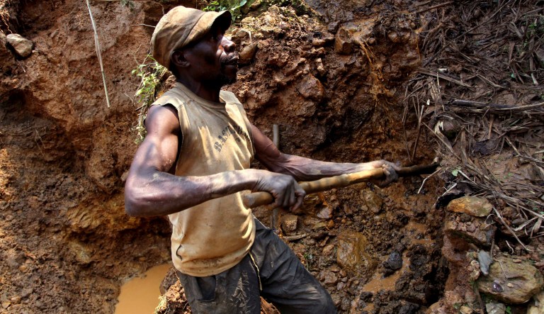 In this Aug. 17, 2012 file photo, a Congolese miner digs for cassiterite, the major ore of tin, at Nyabibwe mine, in eastern Democratic Republic of Congo.