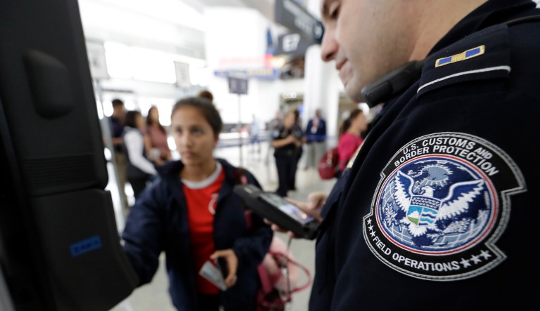 U.S. Customs and Border Protection officer Julio Corro, right, helps a passenger navigate one of the new facial recognition kiosks at a United Airlines gate before boarding a flight to Tokyo, Wednesday, July 12, 2017, at George Bush Intercontinental Airport, in Houston. 