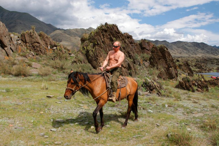 Vladimir Putin riding a horse while traveling in the mountains of the Siberian Tyva region.