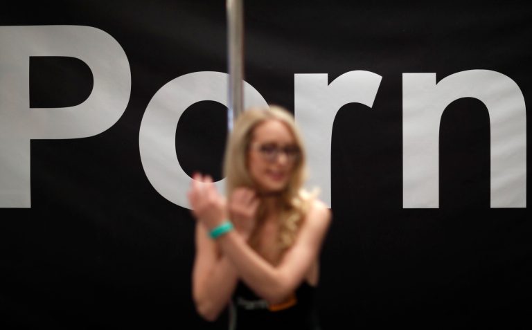 Pornography actress Ginger Banks stands in the Pornhub booth during the AVN Adult Entertainment Expo on Wednesday, Jan. 24, 2018, in Las Vegas.